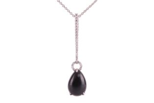 A Whitby jet and diamond drop pendant on chain, featuring a teardrop-shaped jet cabochon of 13.0 x