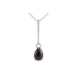 A Whitby jet and diamond drop pendant on chain, featuring a teardrop-shaped jet cabochon of 13.0 x 9