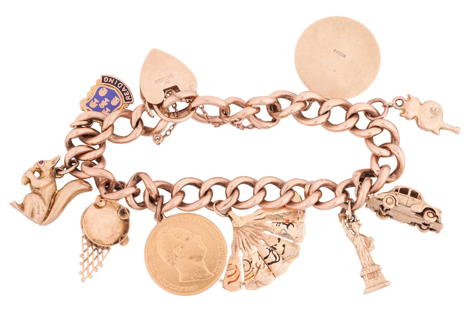 A 9ct gold charm bracelet featuring nine charms including Lady Liberty, a Morris Minor car, a retrac - Image 2 of 3