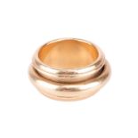 An 18ct gold "Possession" ring, by Piaget. The central band rotates and is set to a wider recessed b