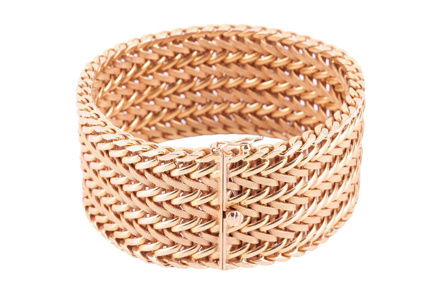 A wide woven link bracelet, flat with textured details, completed with a concealed push button clasp