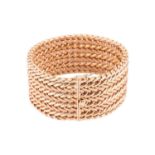 A wide woven link bracelet, flat with textured details, completed with a concealed push button clasp