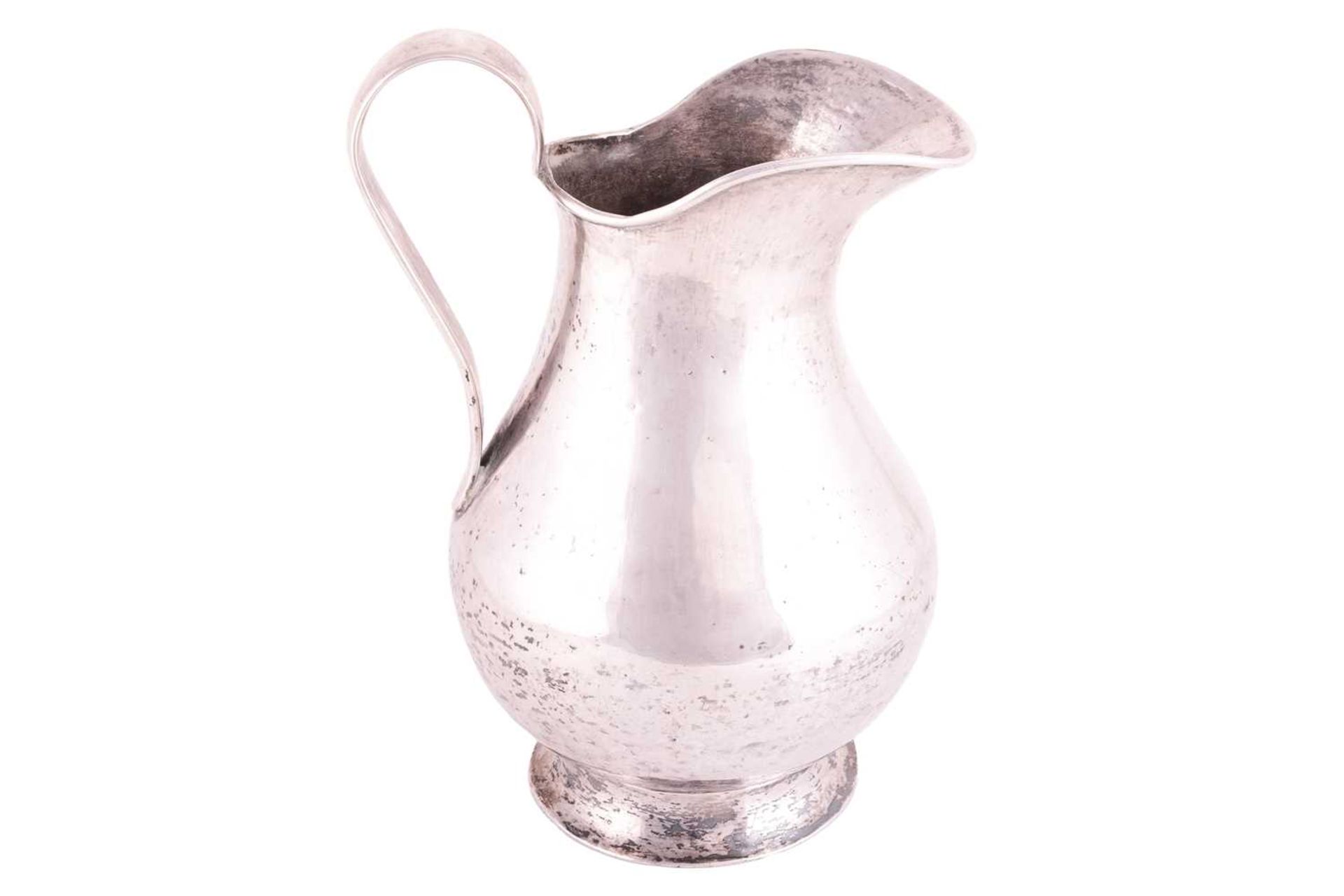 A white metal jug possibly Bolivian of baluster form with a tapered loop handle and flared foot, 23  - Image 2 of 3