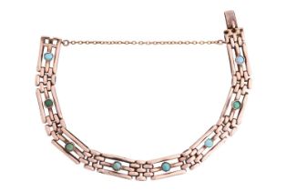 A gate bracelet set with turquoise, formed of bar links in the gate design, set with cabochon