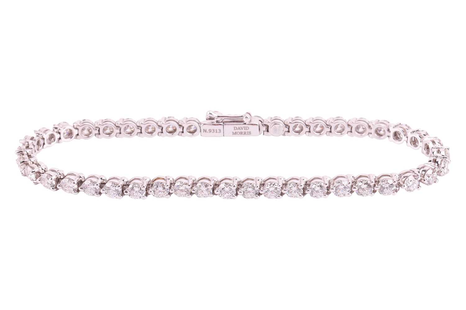 A diamond line bracelet by David Morris, claw set with 44 round brilliant diamonds measuring