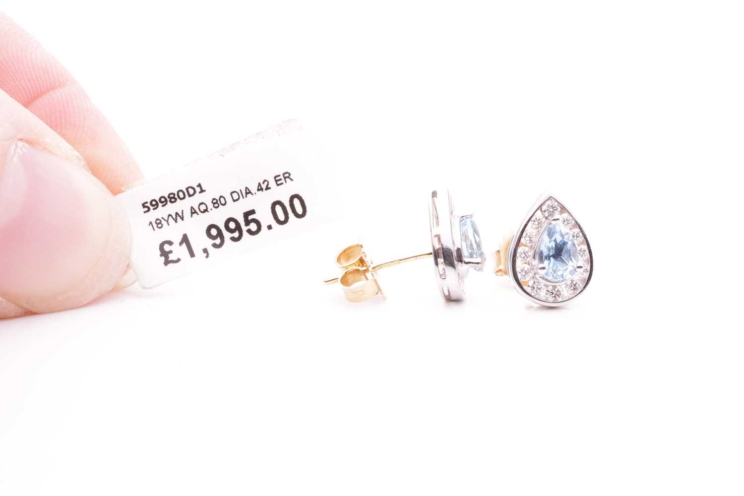 A pair of aquamarine and diamond stud earrings, each featuring a pear cut aquamarine with an estimat - Image 3 of 3