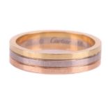 Cartier - a Vendôme Louis Cartier wedding band in 18ct tri-coloured gold, constructed by three integ