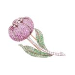 A gem-set brooch of tulip form, flowerhead mount with millgrain edges, comprising layered petals enc