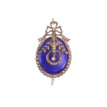 A Victorian enamel and seed pearl brooch, the oval panel with textured work and blue enamel, applied