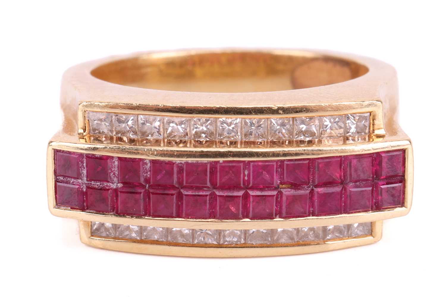 A diamond and ruby-set angular dress ring, featuring calibré-cut rubies set between two rows of prin