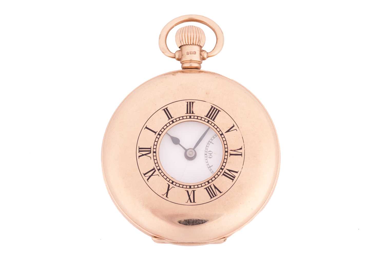 A 9ct gold half-hunter pocket watch featuring a keyless wound Swiss movement in a yellow gold case m