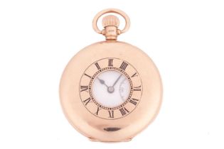 A 9ct gold half-hunter pocket watch featuring a keyless wound Swiss movement in a yellow gold case m