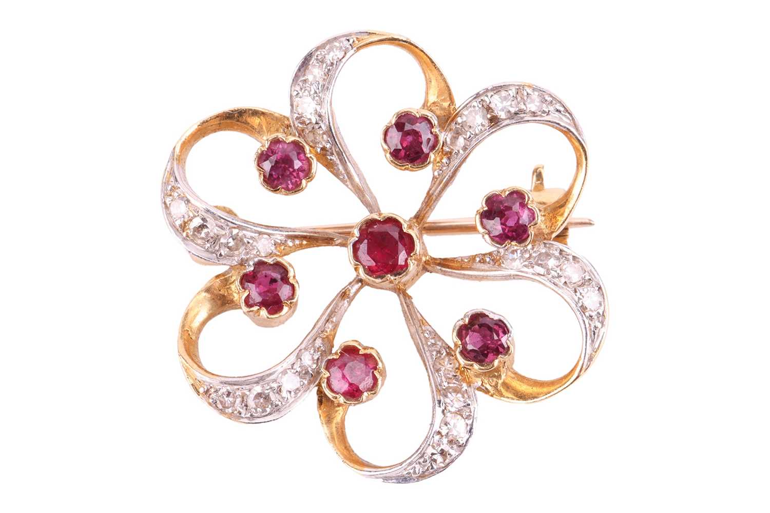 A ruby and diamond brooch, designed as a stylised flower set with rubies, with single cut diamonds s