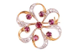 A ruby and diamond brooch, designed as a stylised flower set with rubies, with single cut diamonds