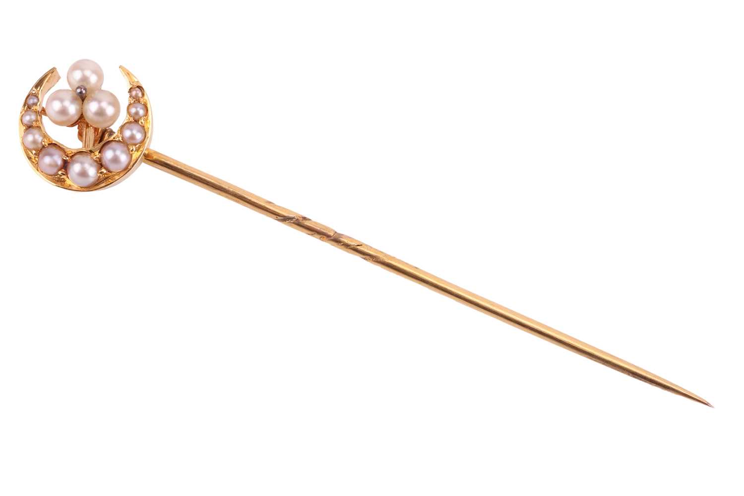 A seed pearl crescent stick pin, the crescent measuring 11mm diameter, with a seed pearl trefoil clu