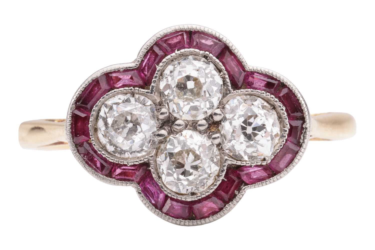 An Art Deco diamond and ruby quatrefoil ring, the panel is constructed by four old-cut diamonds with
