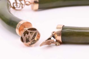 Two Chinese nephrite bracelets, comprising curved nephrite bars, flanked with pierced spacers