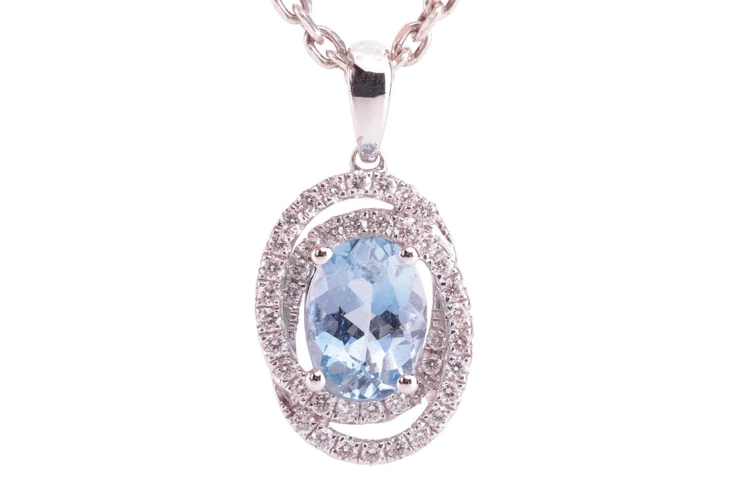An aquamarine and diamond-set oval pendant, featuring an oval aquamarine, with an estimated carat we