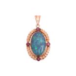 An opal and ruby pendant, featuring a large oval cabochon of a precious opal of 2.4 x 1.5 cm, displa