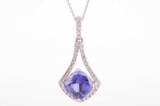 A tanzanite and diamond-set drop pendant, featuring a cushion-cut tanzanite measuring