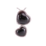 A Whitby jet and diamond double heart pendant on chain, featuring two heart-shaped jet cabochons, fr