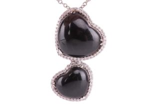 A Whitby jet and diamond double heart pendant on chain, featuring two heart-shaped jet cabochons,