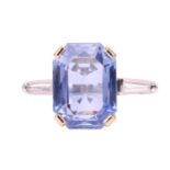 An unheated Ceylon sapphire and diamond dress ring, claw-set with an octagonal-cut sapphire of purpl