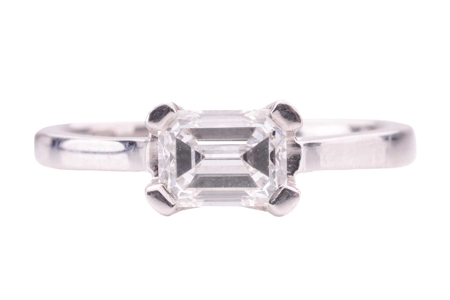 A diamond solitaire ring, featuring an emerald-cut diamond, with an estimated carat, colour and clar