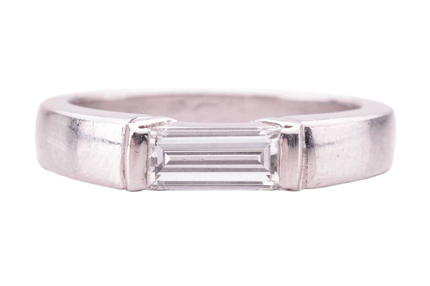 A diamond solitaire platinum ring, featuring a baguette-cut diamond, with an estimated carat weight 