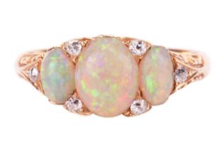 An opal and diamond half-hoop ring, featuring three graduated oval cabochons, displaying spectral