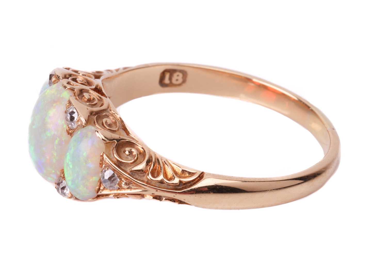 An opal and diamond half-hoop ring, featuring three graduated oval cabochons, displaying spectral pl - Image 3 of 4