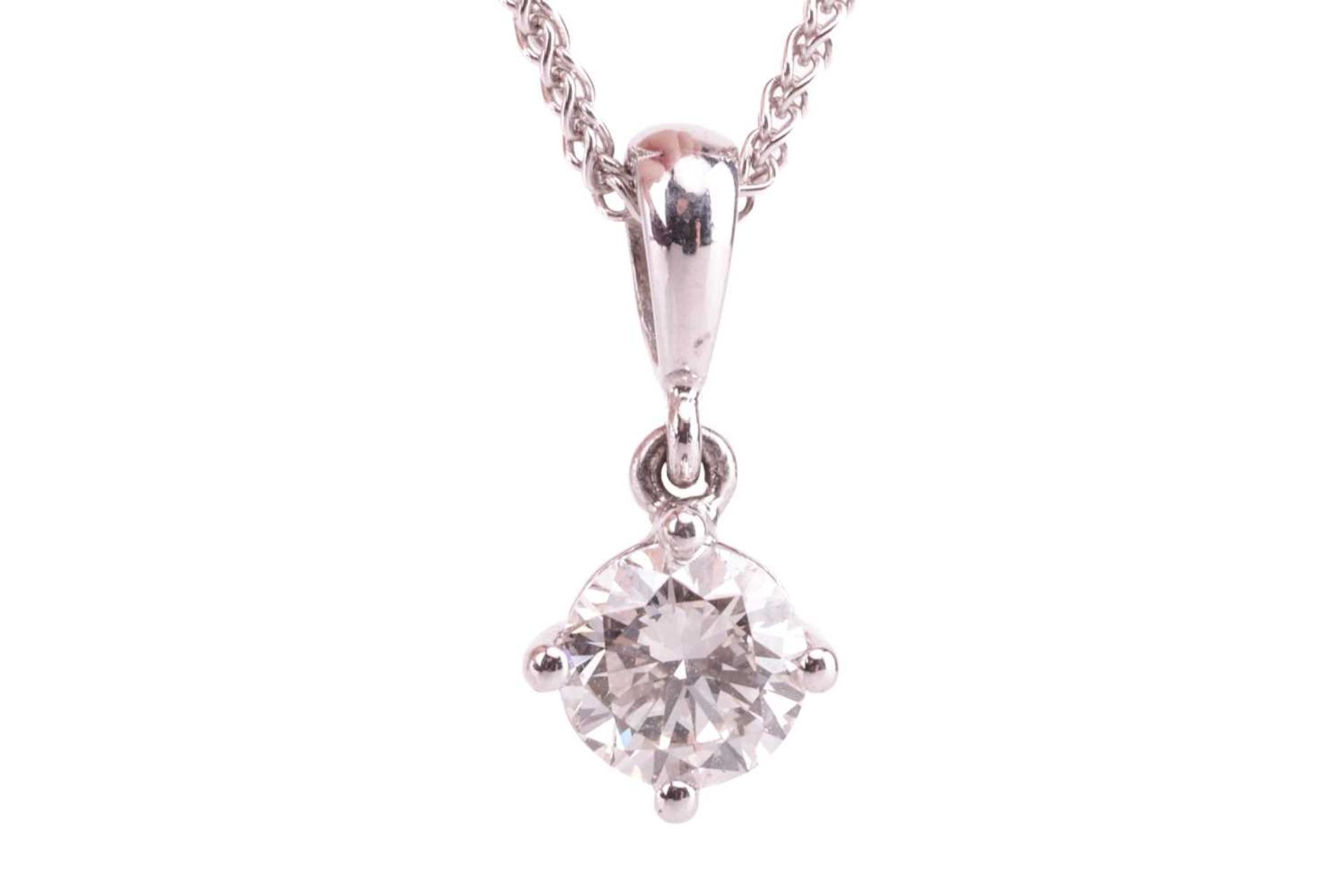 A diamond solitaire pendant, featuring a round brilliant diamond, with an estimated carat weight of 