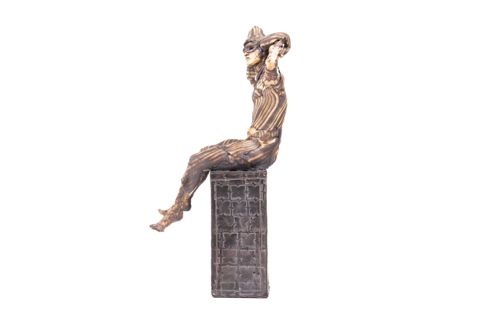 April Young (contemporary), 'Jester', a painted ceramic figure, the jester seated on a rectangular p - Image 6 of 7