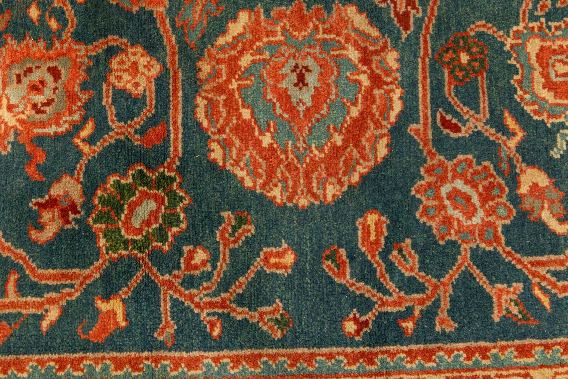 A large Ushak Carpet, the red palmette and leaf design on a blue/green field, within a light red bor - Image 3 of 23