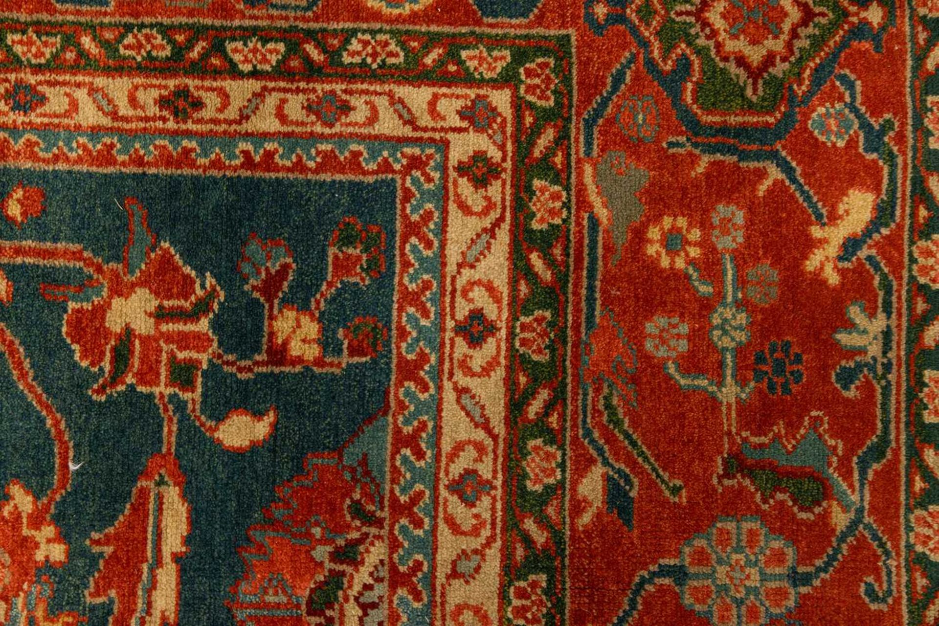 A large Ushak Carpet, the red palmette and leaf design on a blue/green field, within a light red bor - Image 5 of 23
