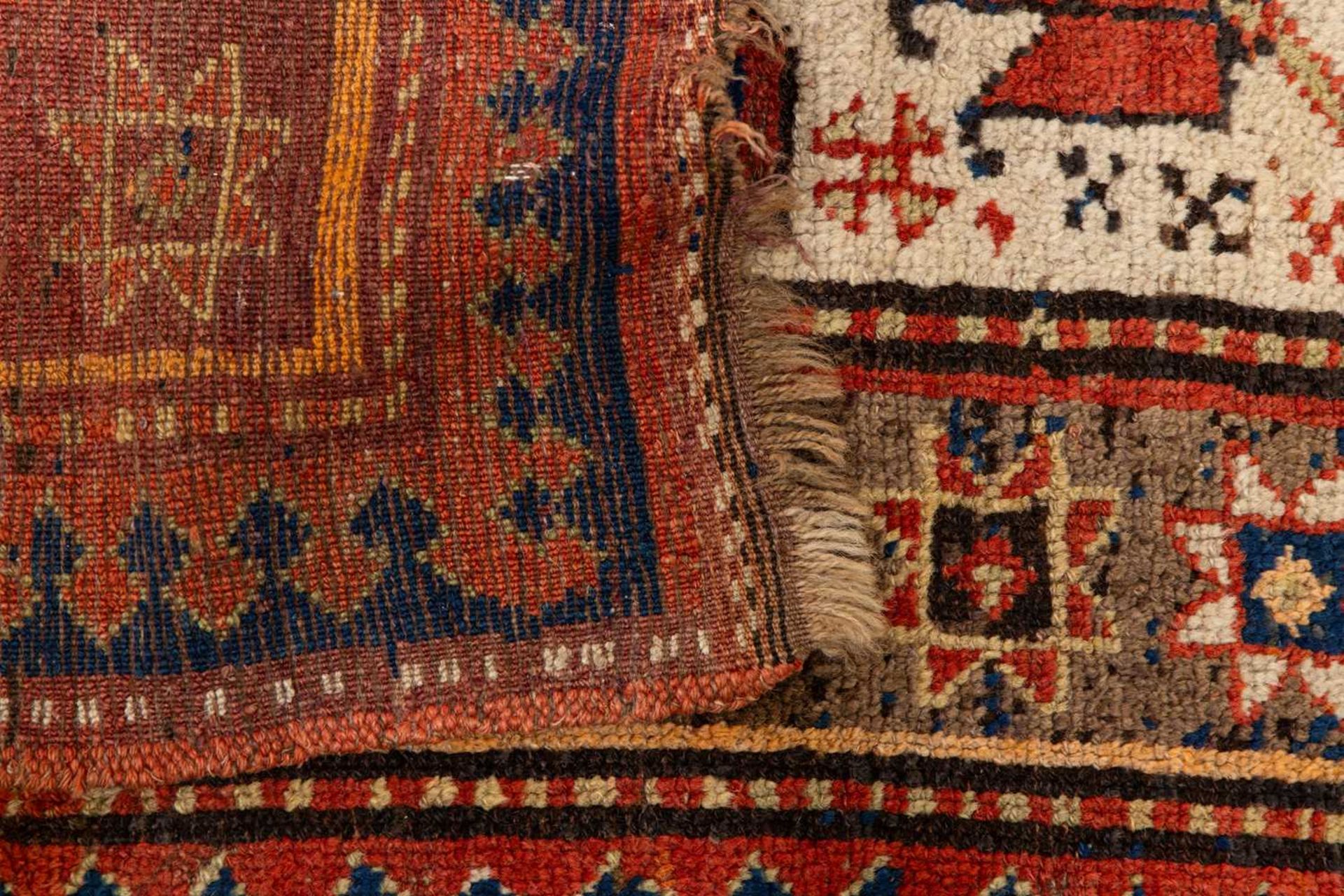 A Kazak Rug, the serrated leaf and medallion design on an ivory field, within a star and serrated bo - Image 3 of 6