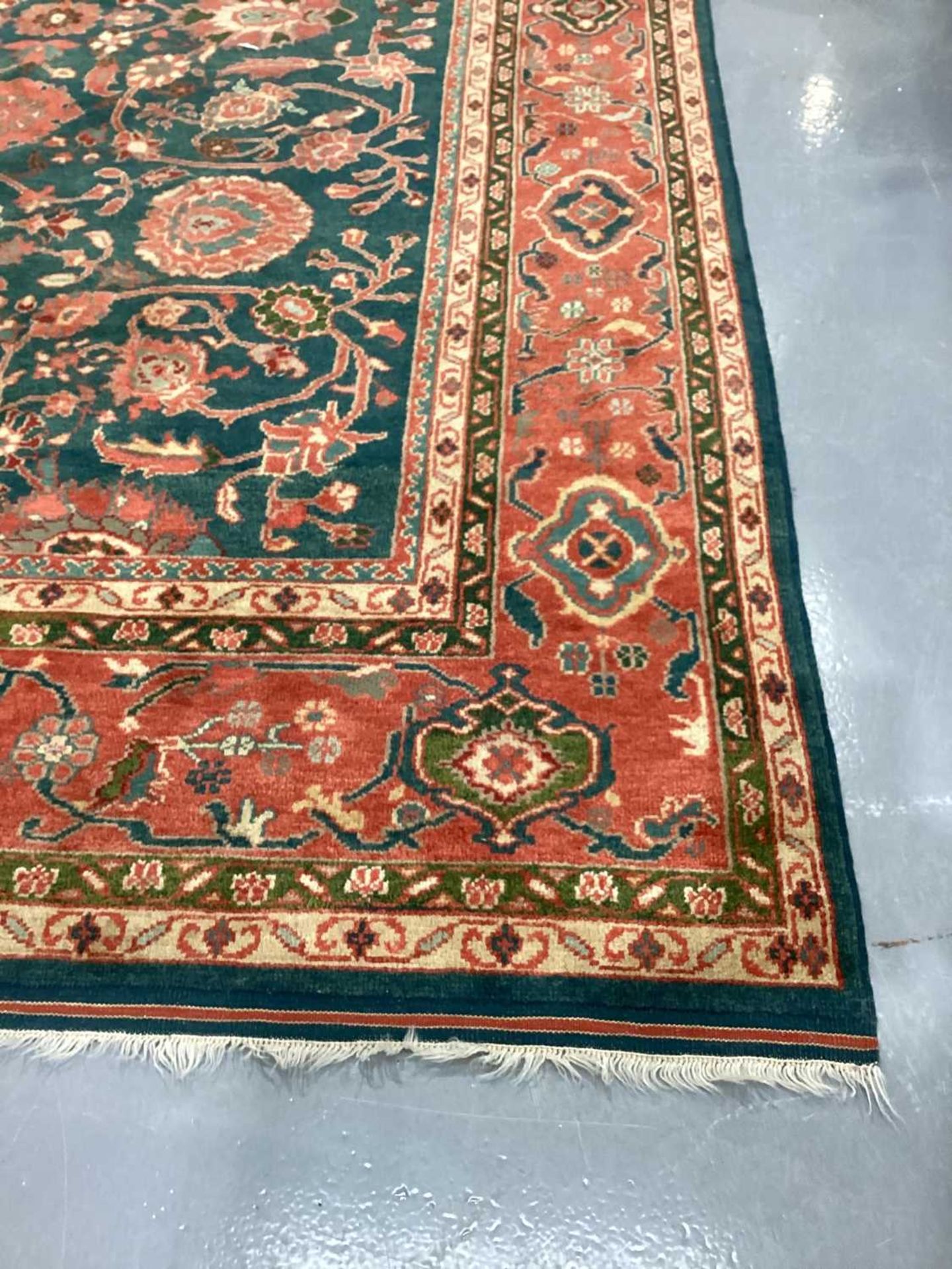 A large Ushak Carpet, the red palmette and leaf design on a blue/green field, within a light red bor - Image 21 of 23