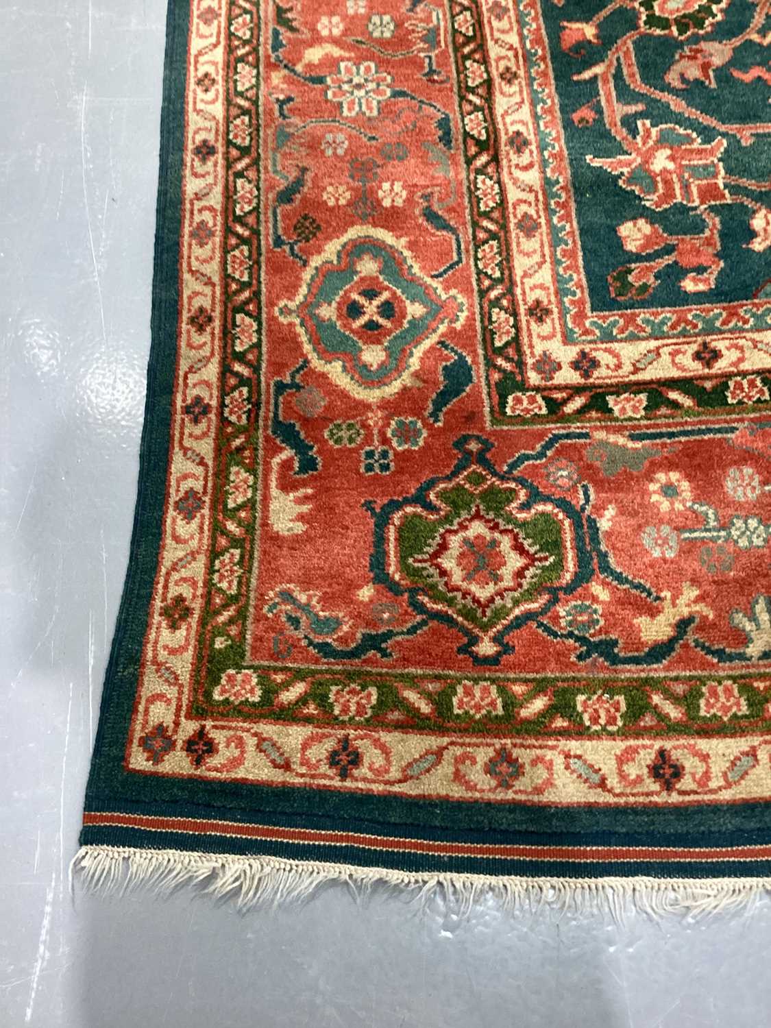 A large Ushak Carpet, the red palmette and leaf design on a blue/green field, within a light red bor - Image 19 of 23