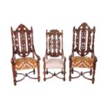 A near pair of Victorian carved oak open armchairs, in the Carolean style, with open S-Scroll, roset