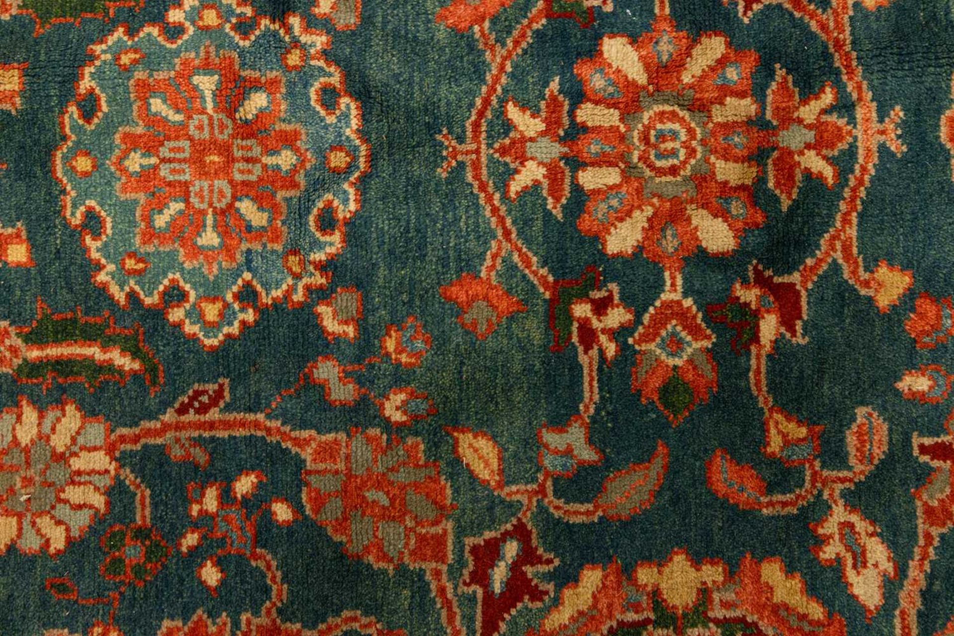 A large Ushak Carpet, the red palmette and leaf design on a blue/green field, within a light red bor - Image 2 of 23