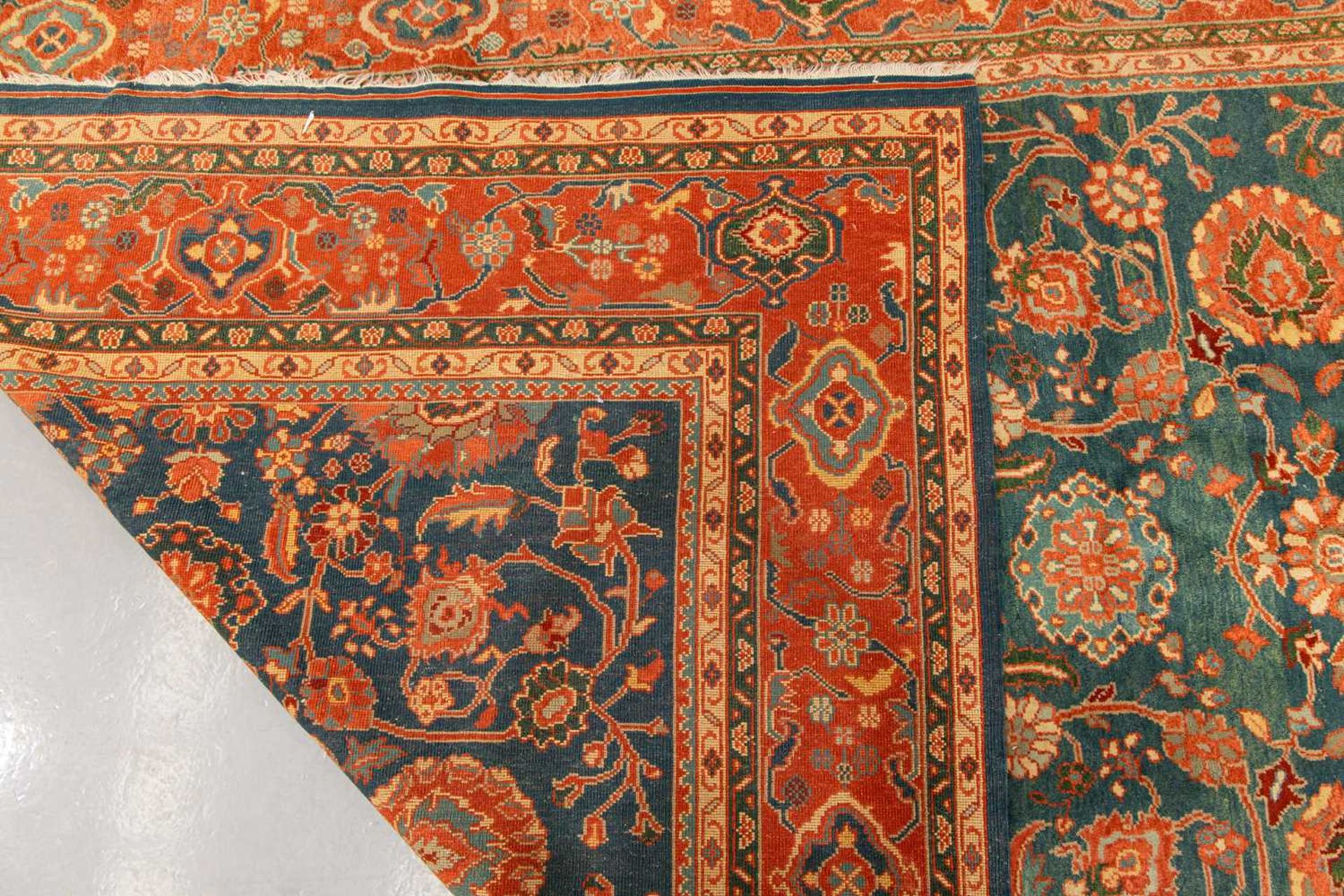 A large Ushak Carpet, the red palmette and leaf design on a blue/green field, within a light red bor - Image 7 of 23