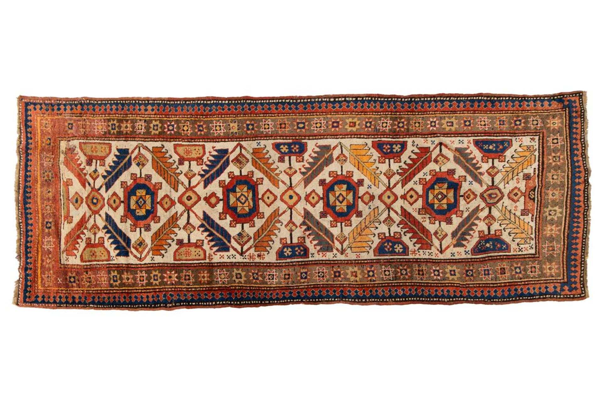 A Kazak Rug, the serrated leaf and medallion design on an ivory field, within a star and serrated bo