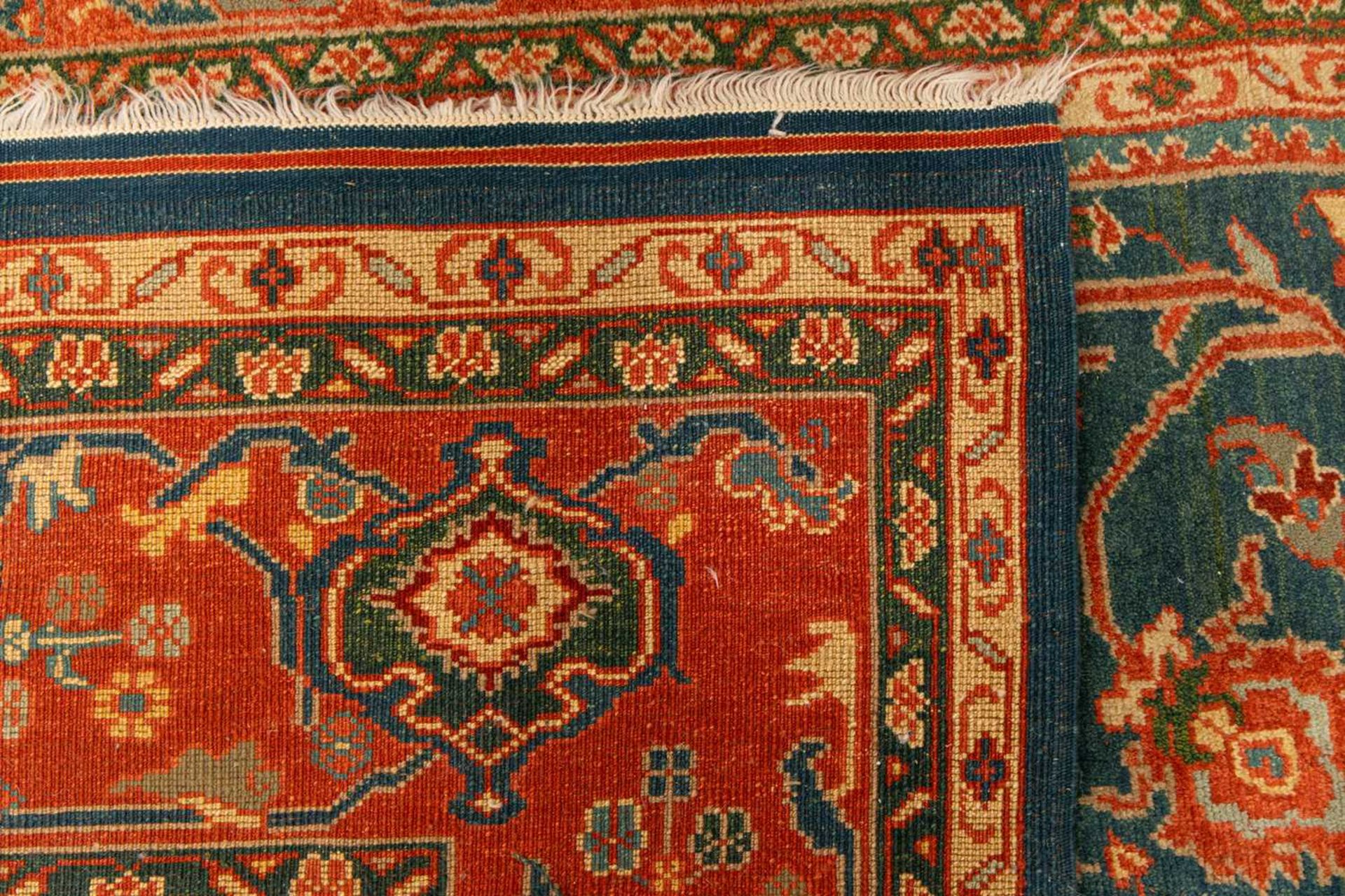 A large Ushak Carpet, the red palmette and leaf design on a blue/green field, within a light red bor - Image 4 of 23