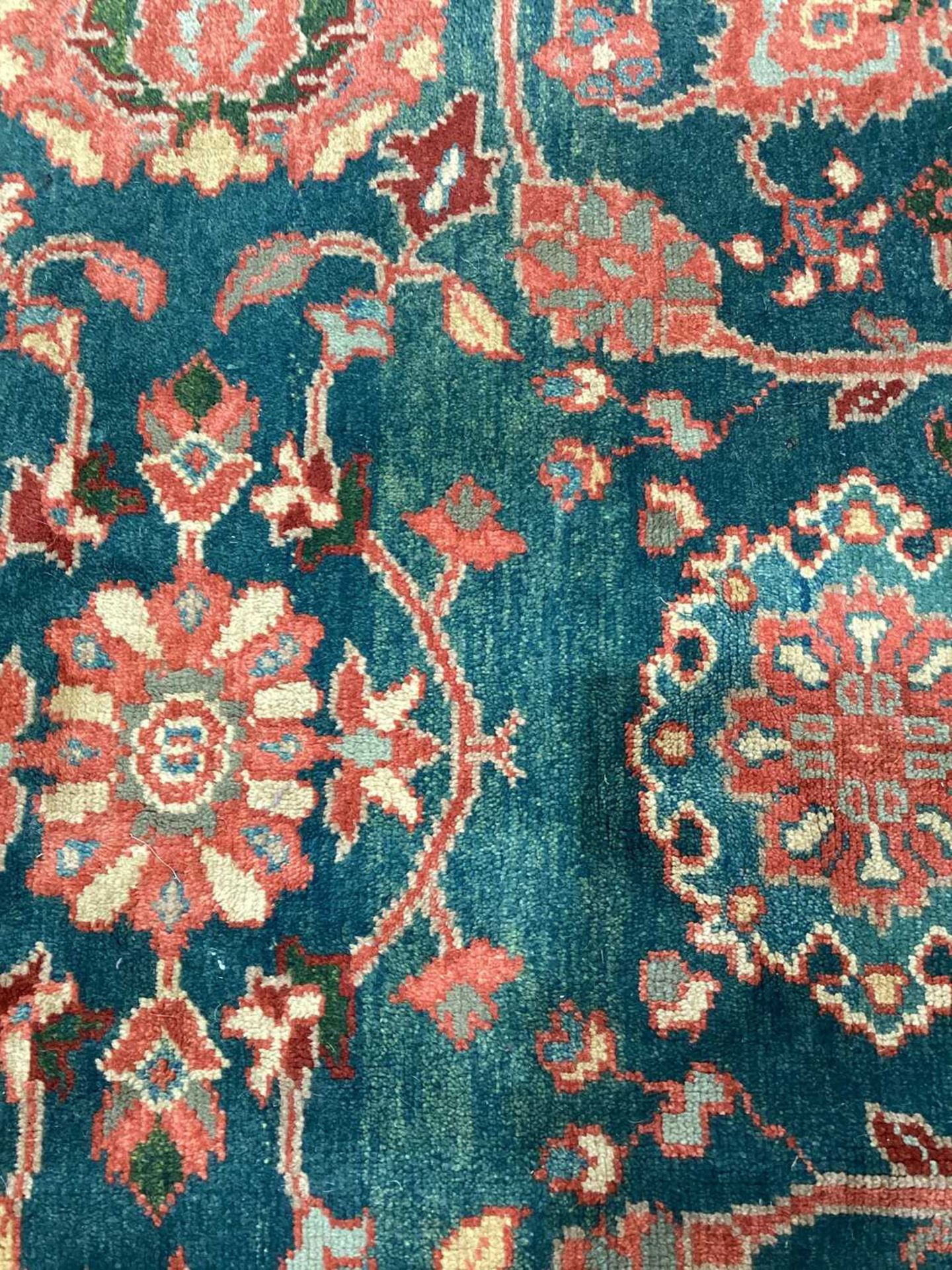 A large Ushak Carpet, the red palmette and leaf design on a blue/green field, within a light red bor - Image 8 of 23