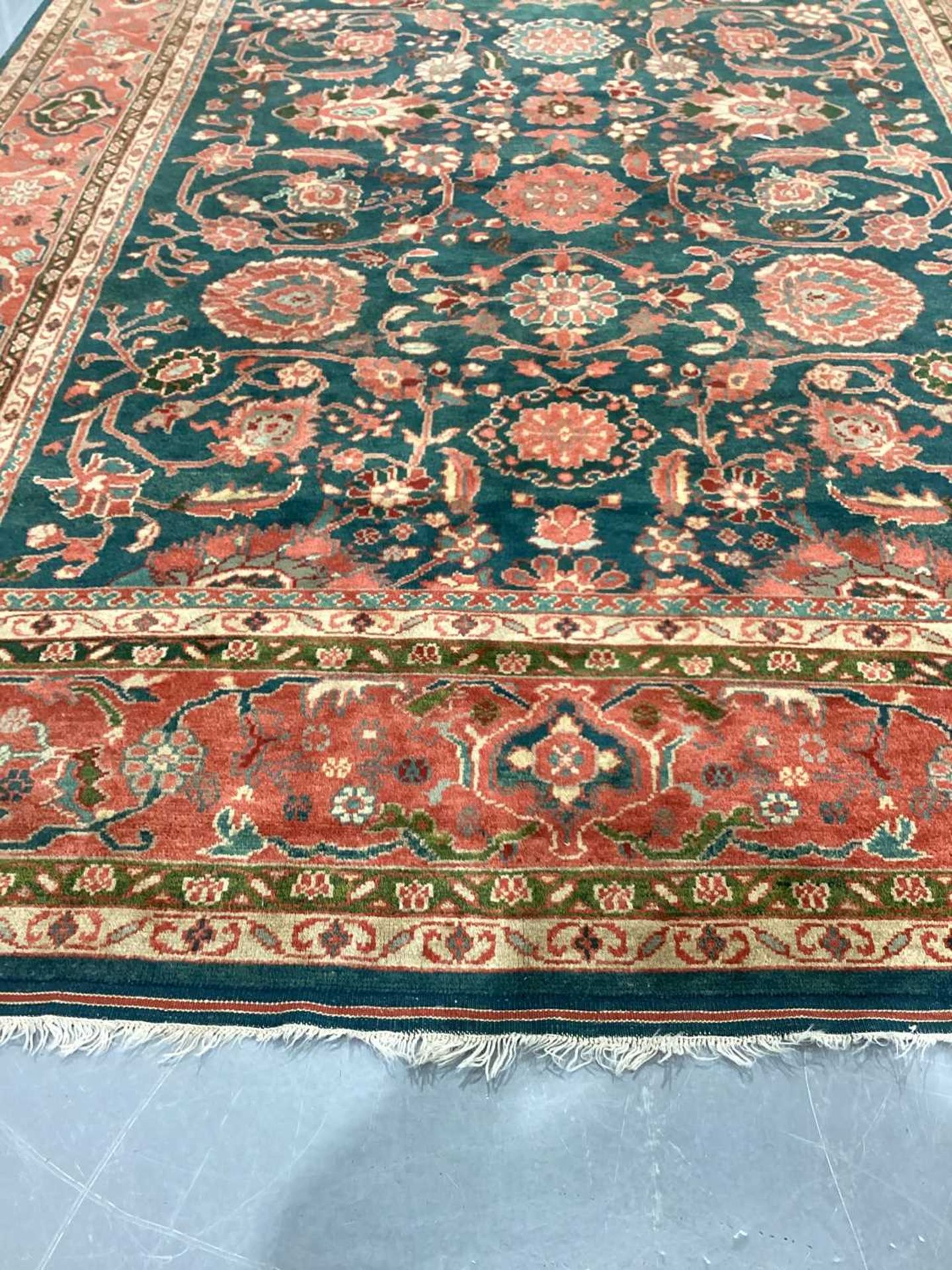 A large Ushak Carpet, the red palmette and leaf design on a blue/green field, within a light red bor - Image 20 of 23