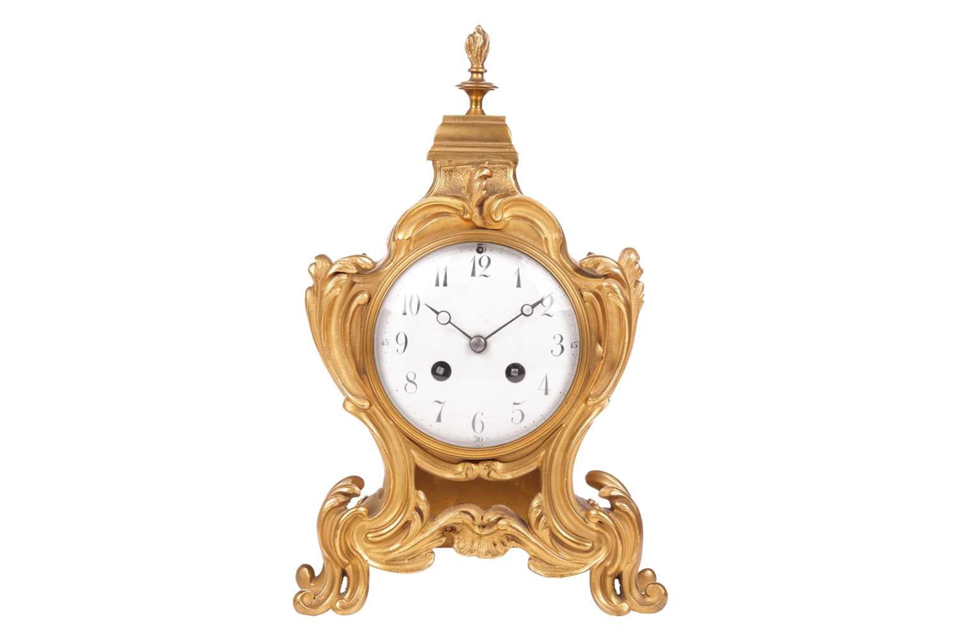 A late 19th/early 20th-century French gilt metal mantel clock, the foliate scroll form case with fla
