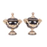 A pair of Neo-classical black lacquer urns and covers, with gilt bronze mounts, mask handles with fl