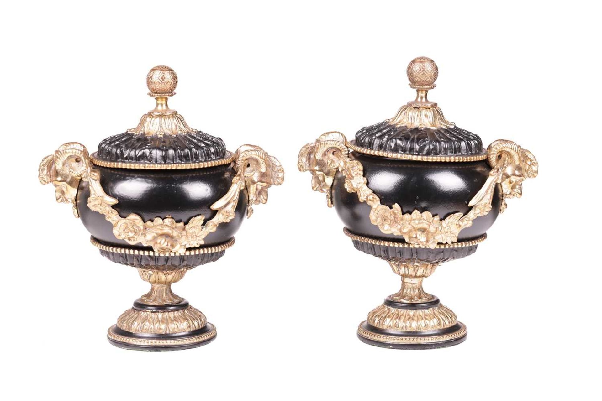 A pair of Neo-classical black lacquer urns and covers, with gilt bronze mounts, mask handles with fl