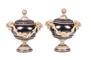 A pair of Neo-classical black lacquer urns and covers, with gilt bronze mounts, mask handles with