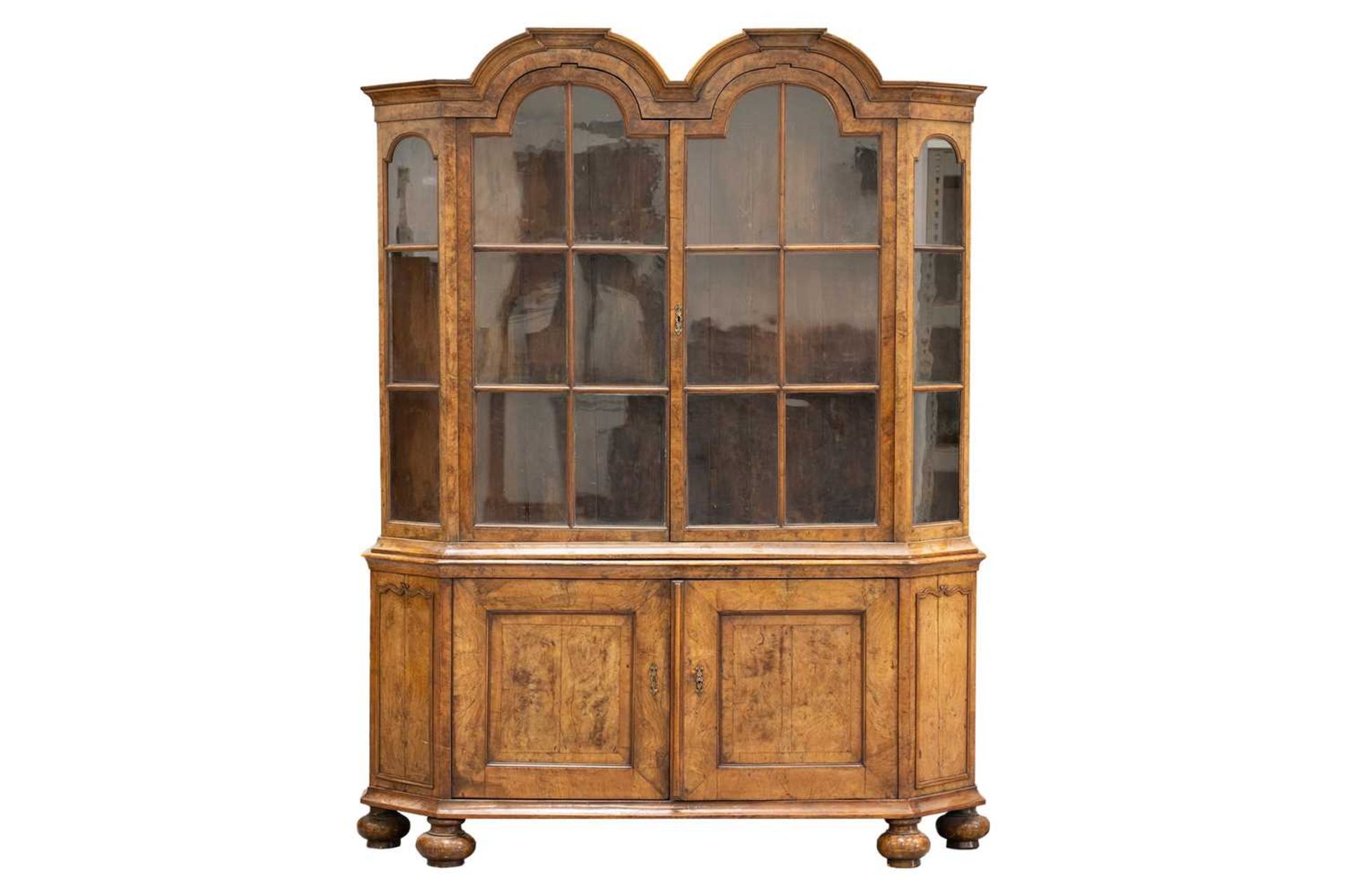 An early 18th-century style figured walnut double domed Dutch "Delft" canted display cabinet, early 